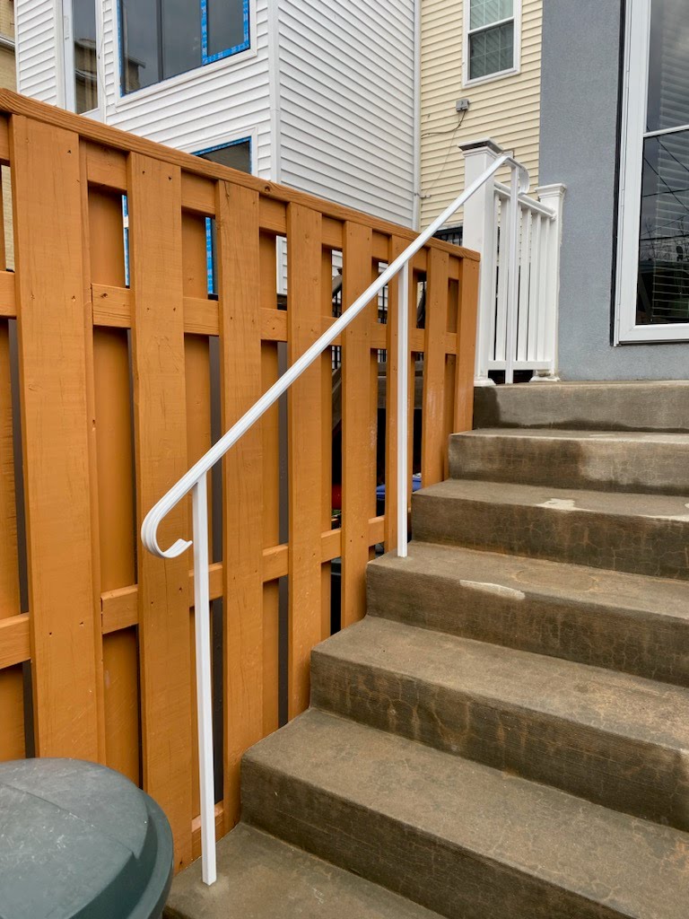 Iron Handrail installed on concrete steps at the back entrance of a house in Silverspring, MD