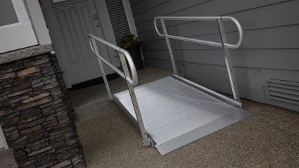 An aluminum wheelchair access ramp installation inside the garange, to help in save movement in and out of house in Potomac, MD