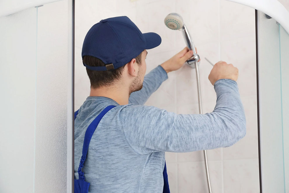 A handyman installing handheld showerhead in Northwest, DC.